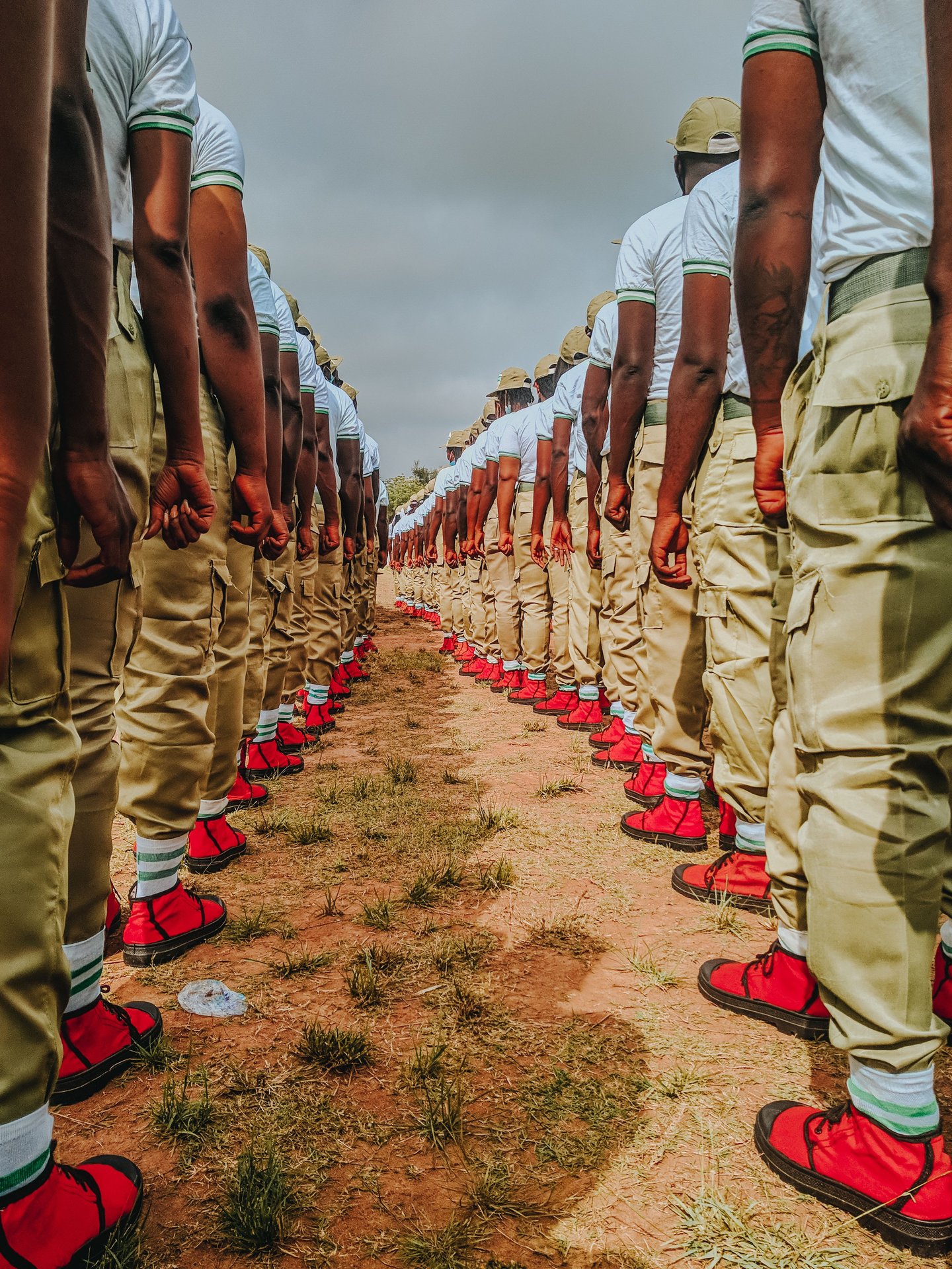 Soldiers in uniform stand in perfect alignment during a mili