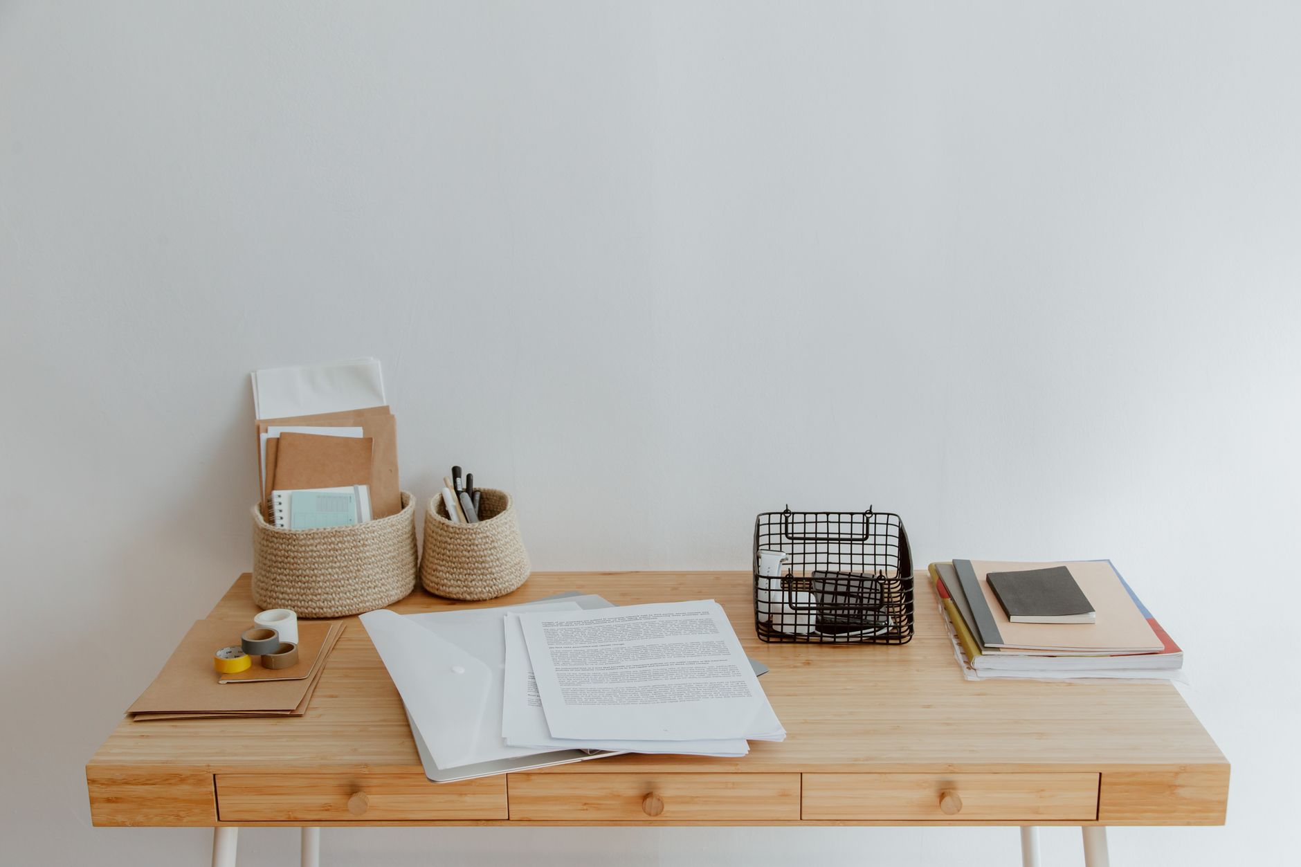 Simple and organized home office desk with minimal supplies,