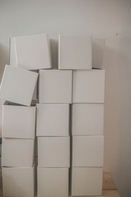 A vertical stack of plain white cardboard boxes creating a m