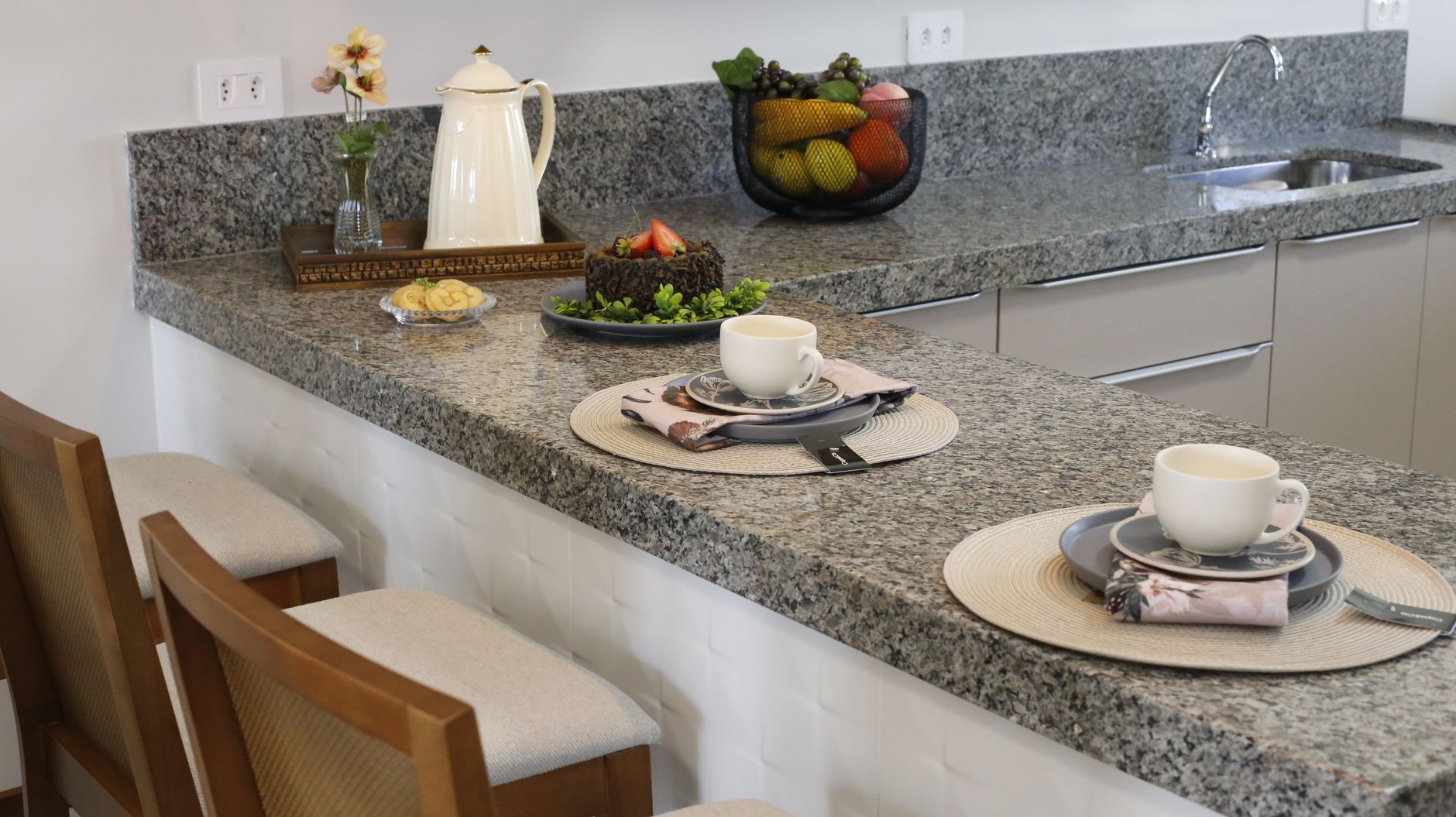 A cozy kitchen counter setup with two places set for breakfa