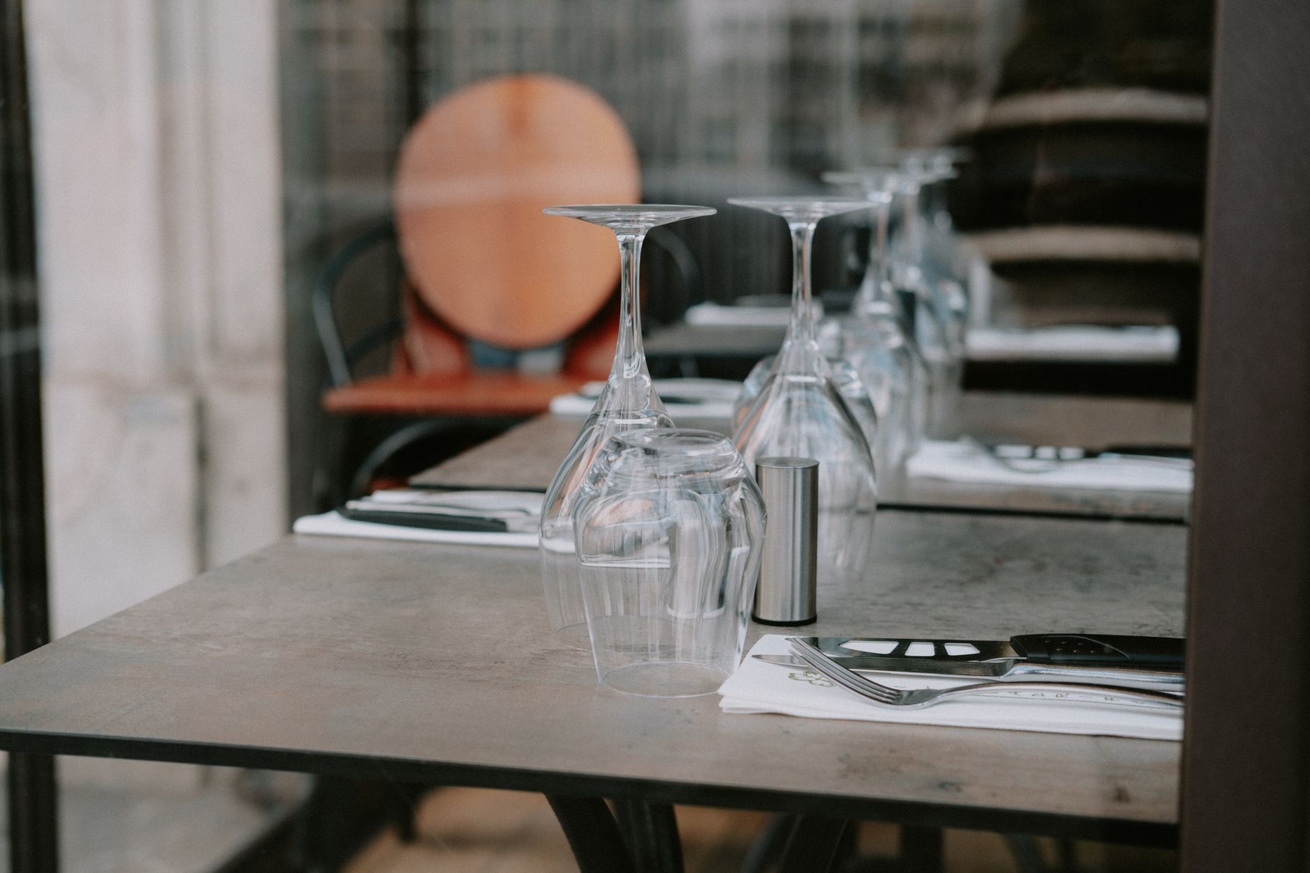Stylish restaurant table setting with upside down glasses an