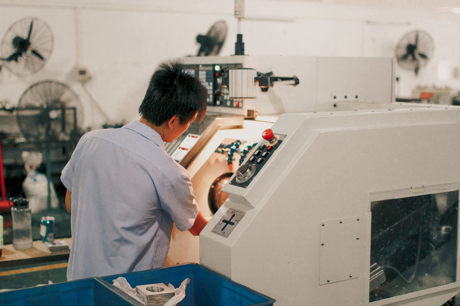 Worker focusing on operating industrial machinery in a facto