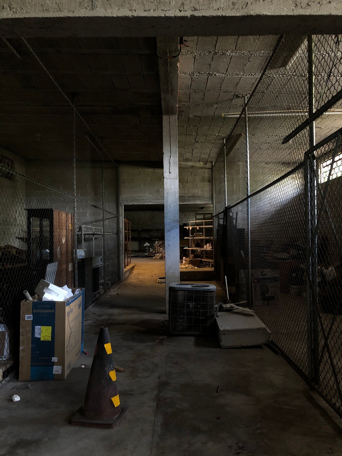 Dull industrial space with boxes and metal fences creating a