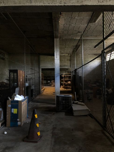 Dull industrial space with boxes and metal fences creating a
