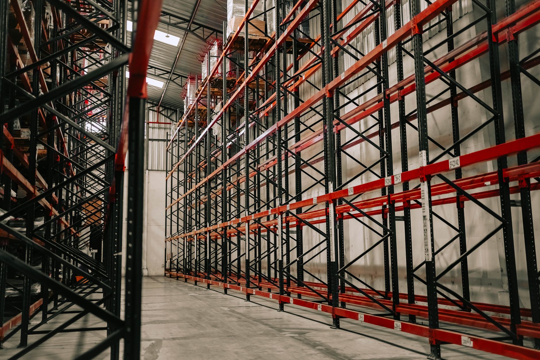 Spacious warehouse interior featuring empty metal racks and