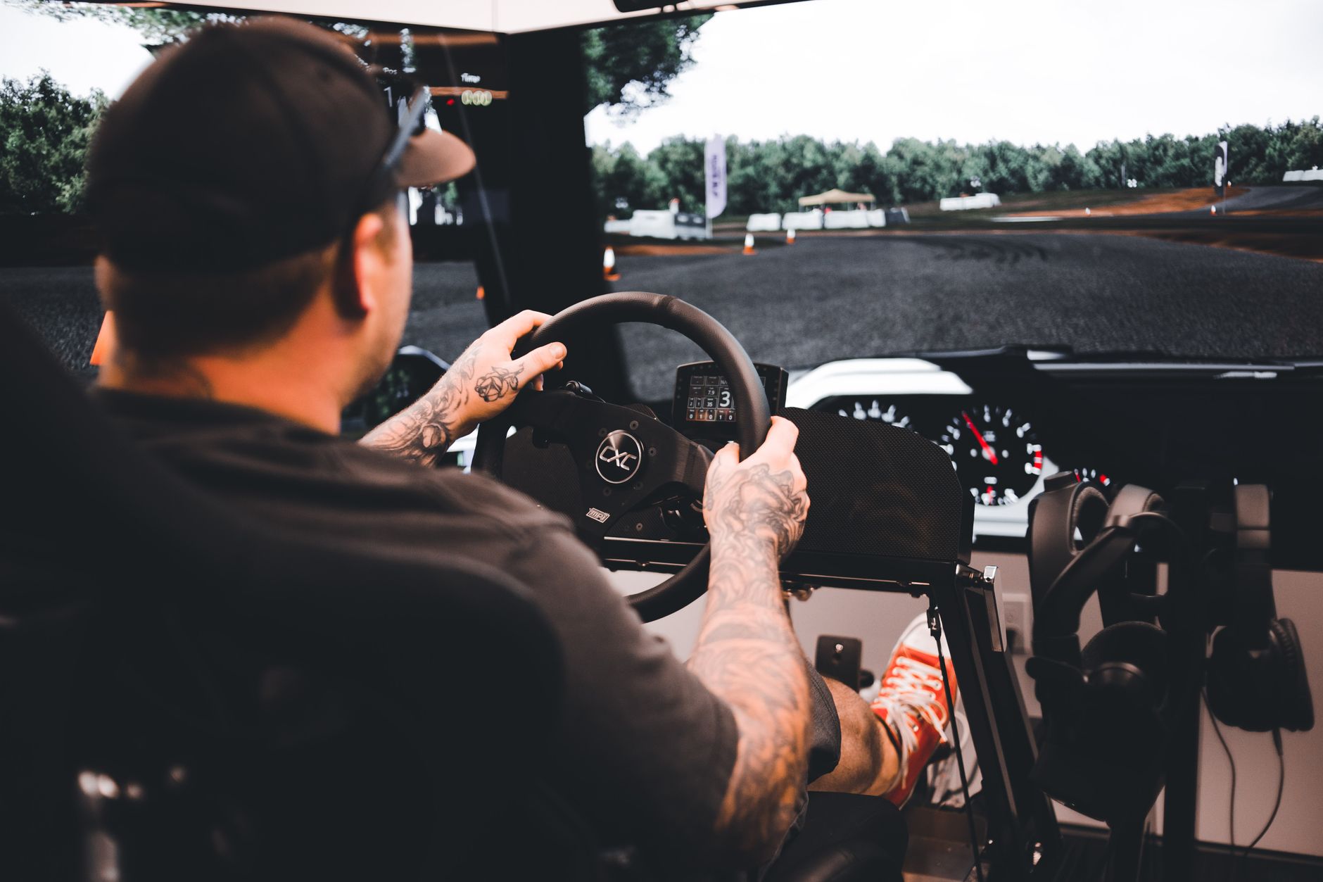 Focused gamer experiencing a detailed driving simulation set