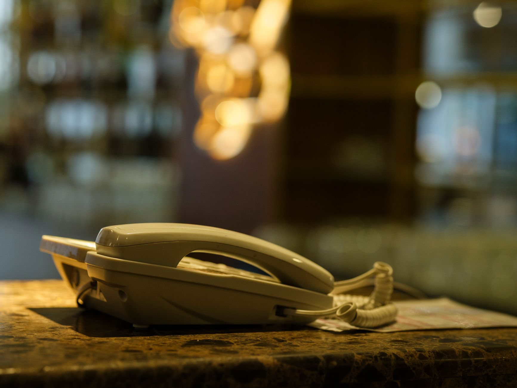 Close-up of a vintage landline phone on a marble counter in