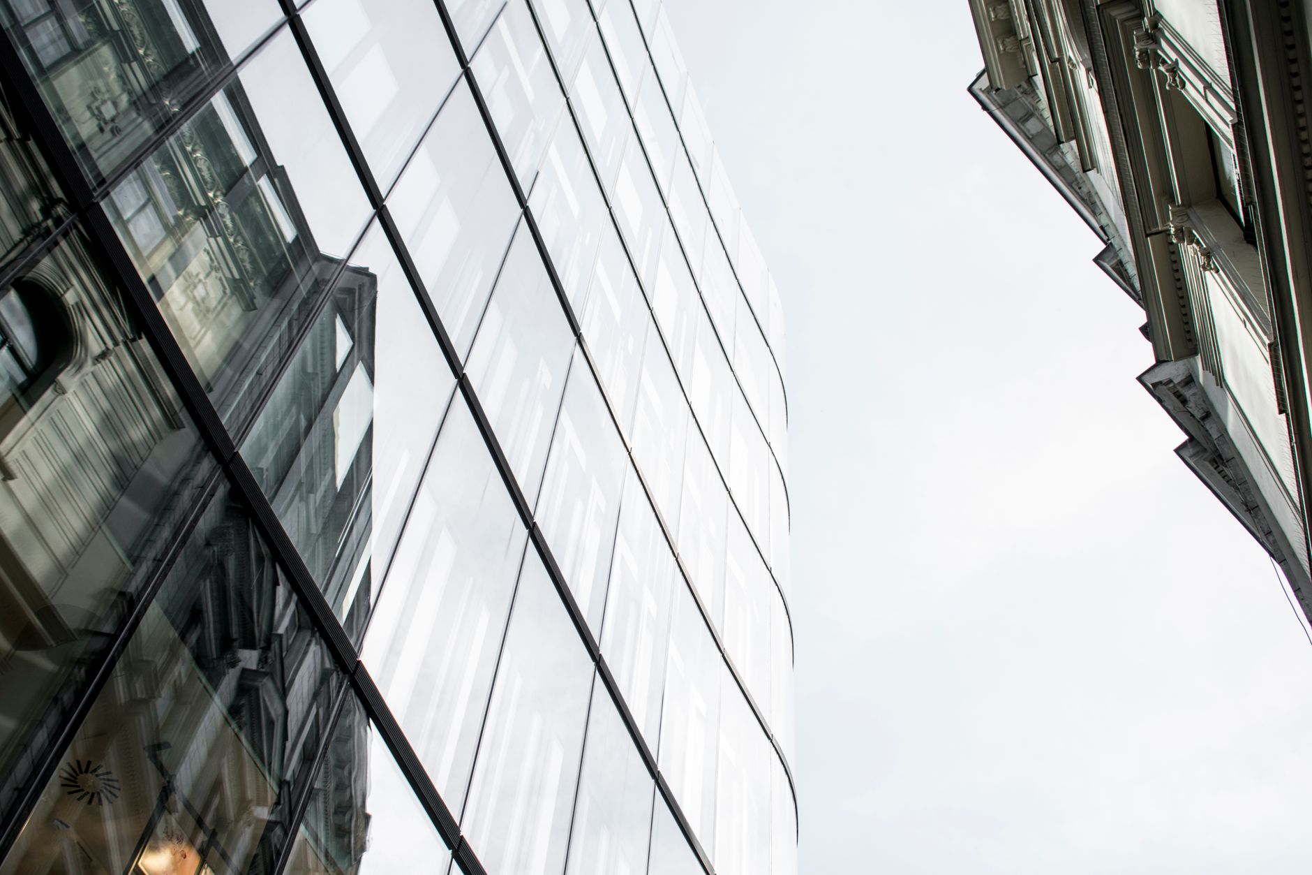 Low angle view of modern glass buildings reflecting the city