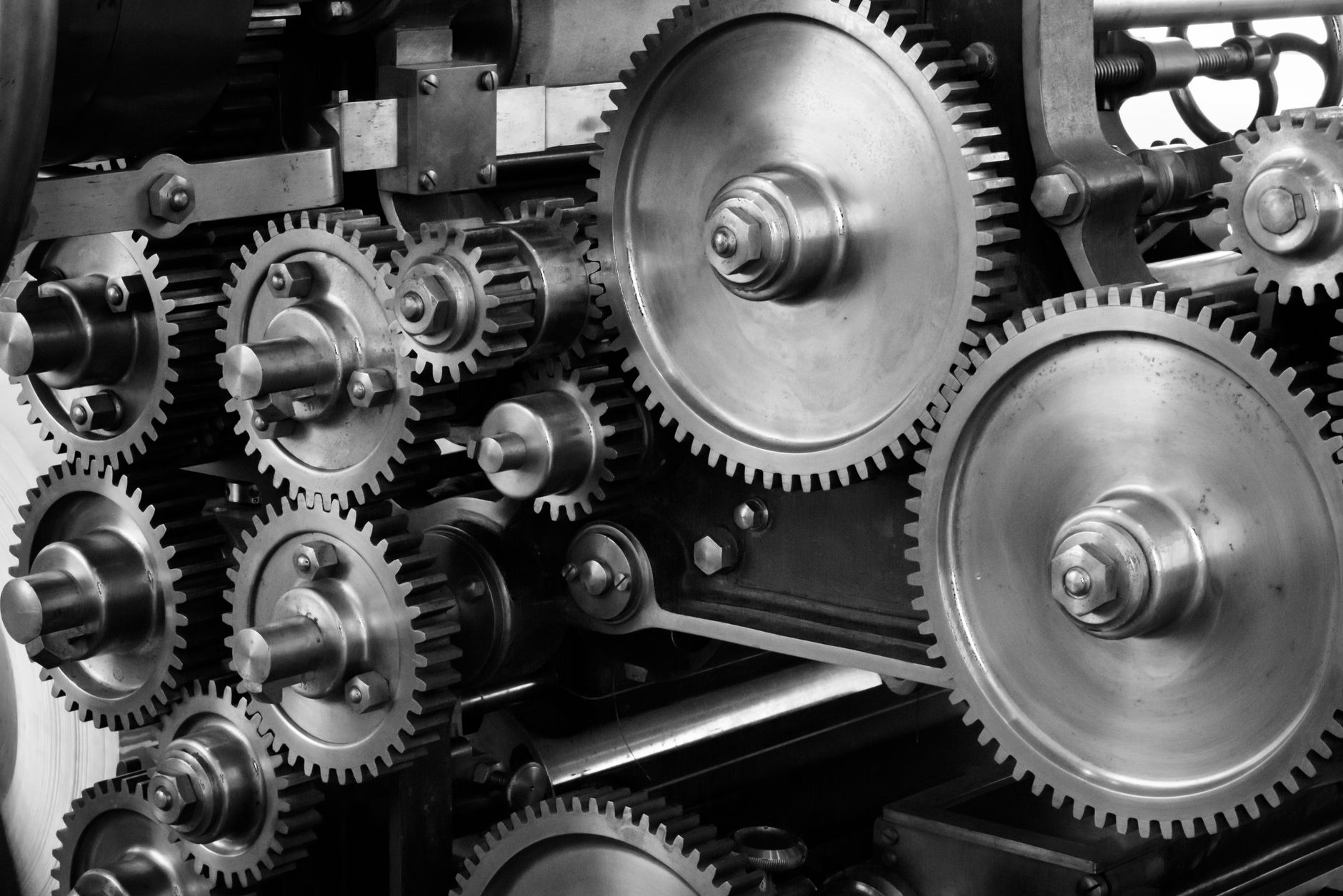 Close-up view of a complex industrial gear mechanism in blac