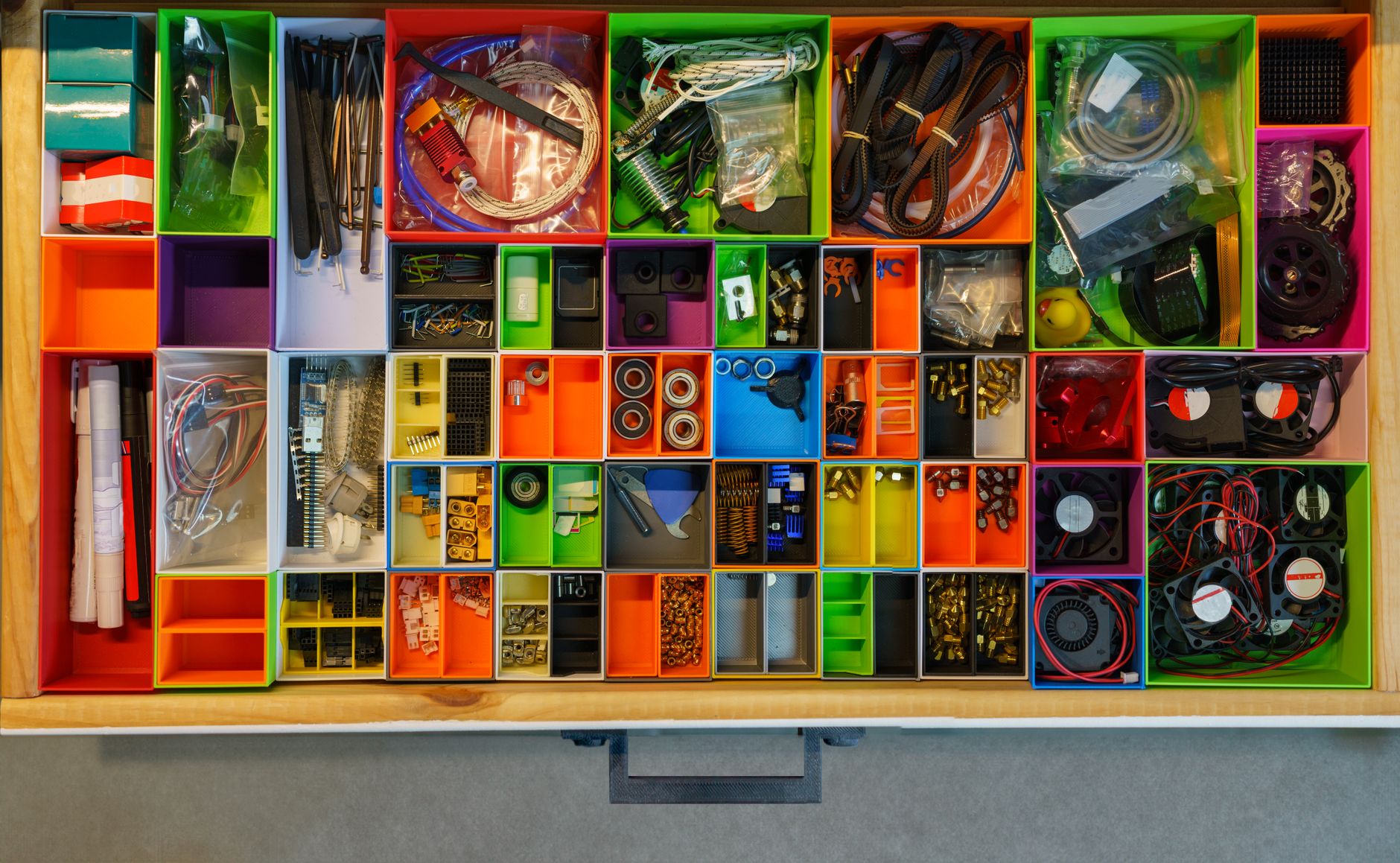 Top view of a neatly organized drawer filled with colorful c