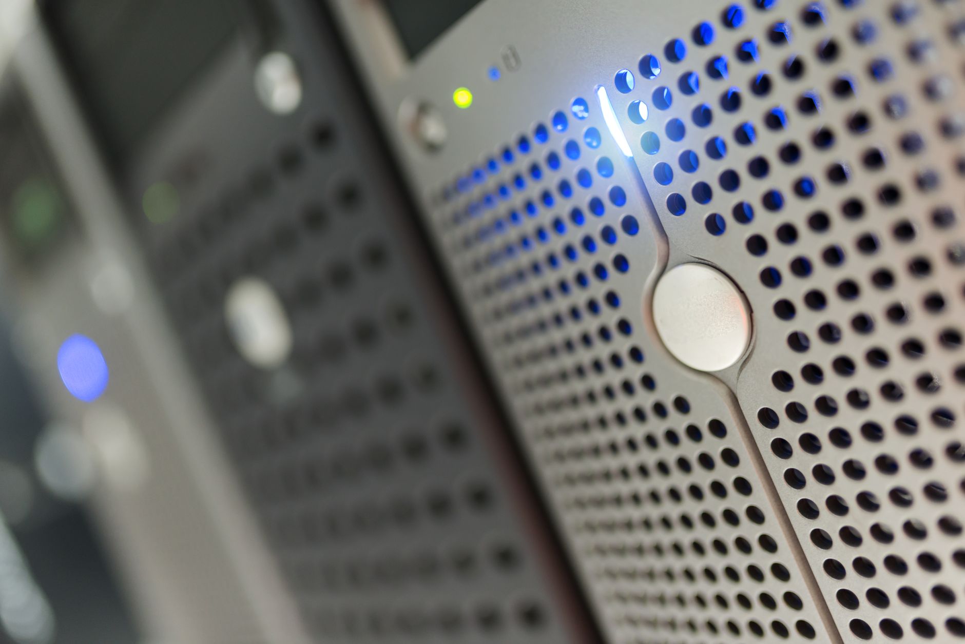 Focused detail of a modern server rack with blue LED indicat