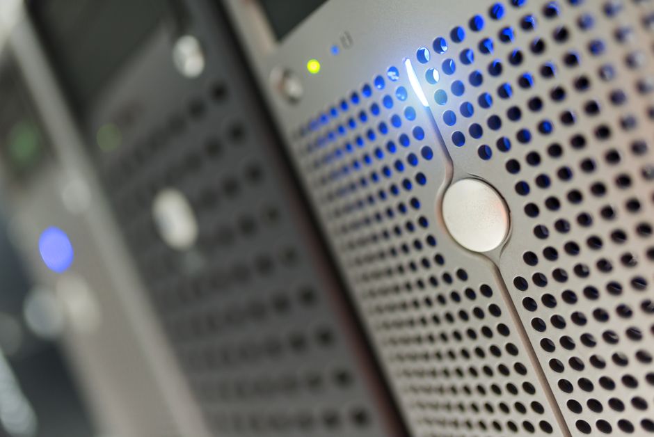 Focused detail of a modern server rack with blue LED indicat