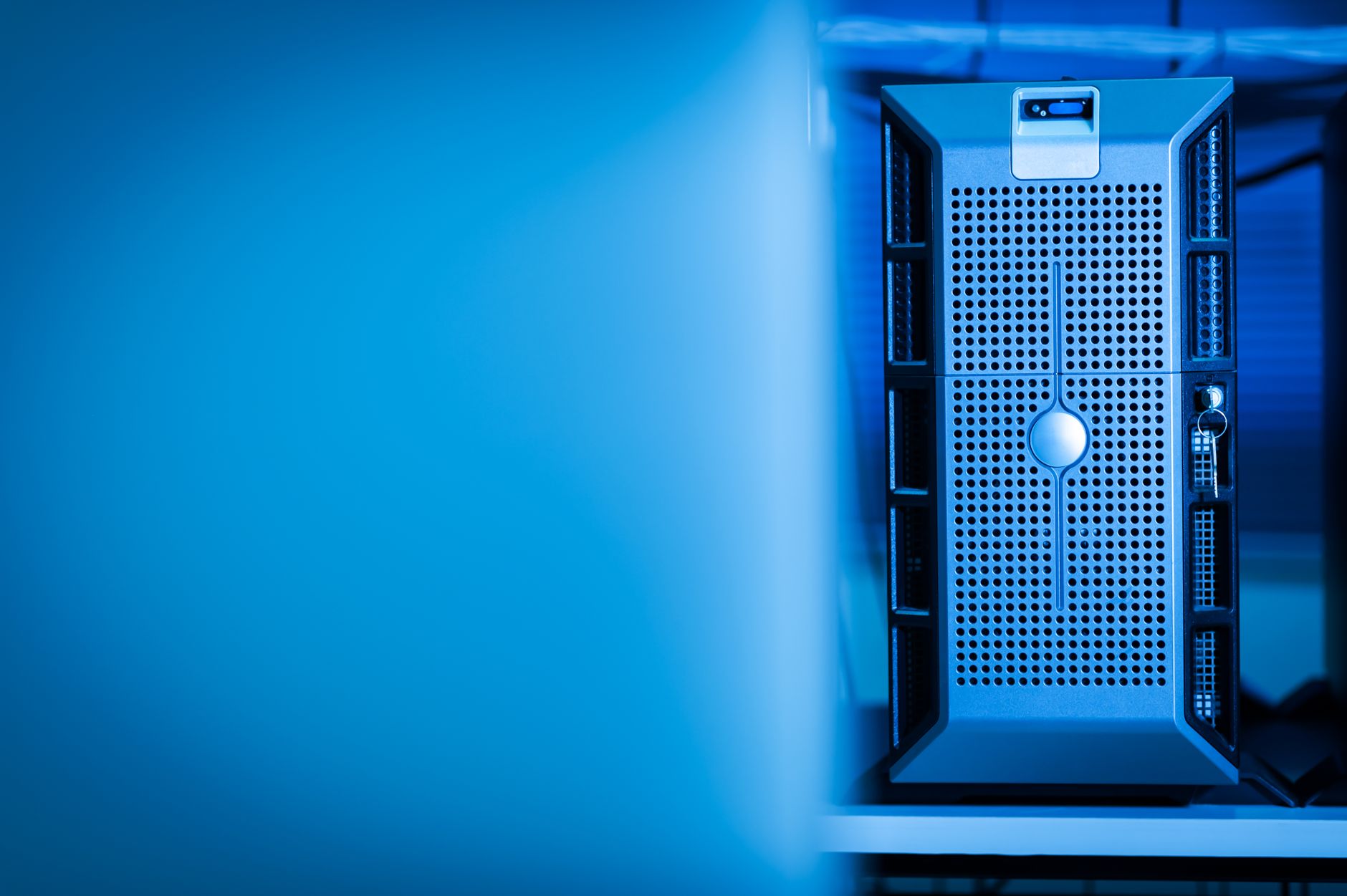 Close-up of a modern server unit in a blue-lit data center e