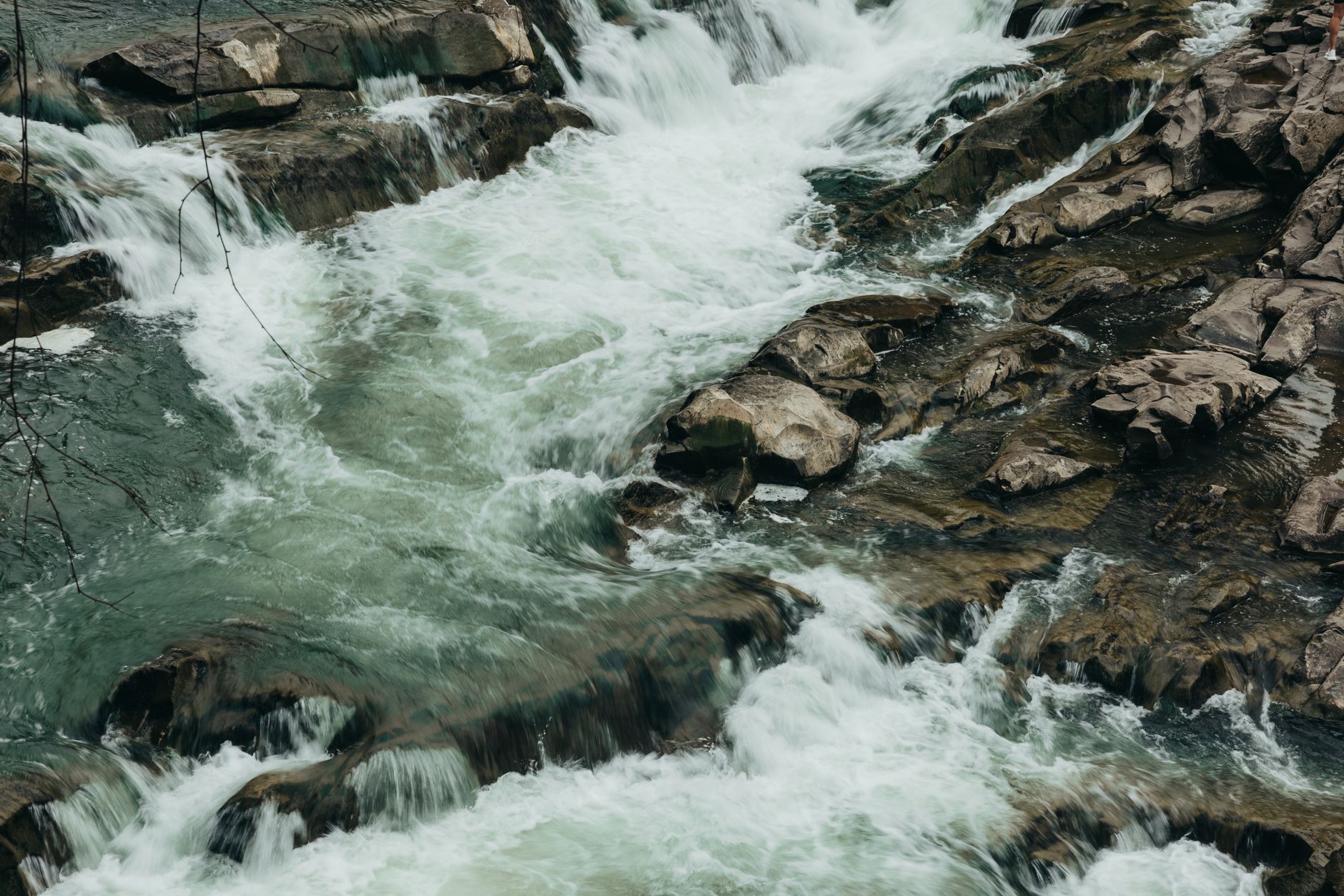 Dynamic river rapids flowing over rugged rocks, showcasing n