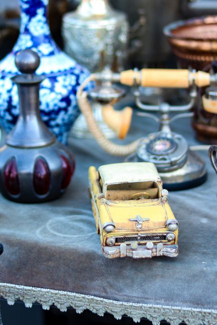 A collection of vintage items including a yellow toy car and
