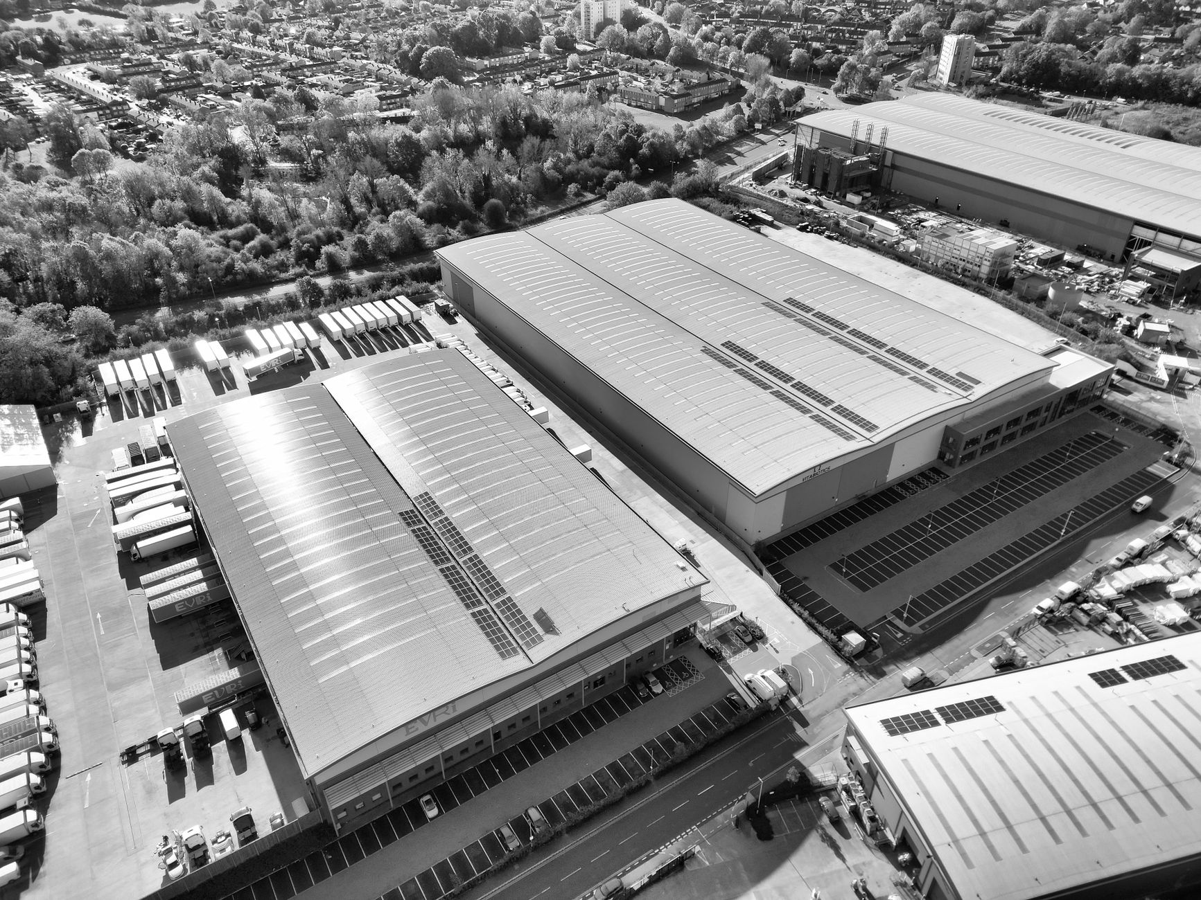 Aerial monochrome image of industrial warehouses and parking