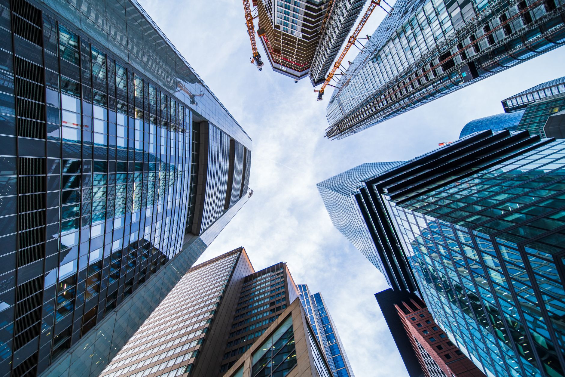 Modern skyscrapers with reflective glass facades stretching
