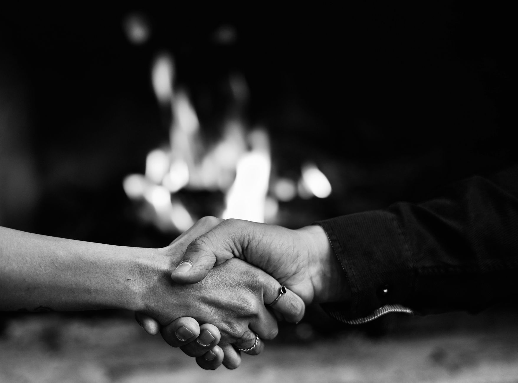 A captivating black and white image of a handshake in front