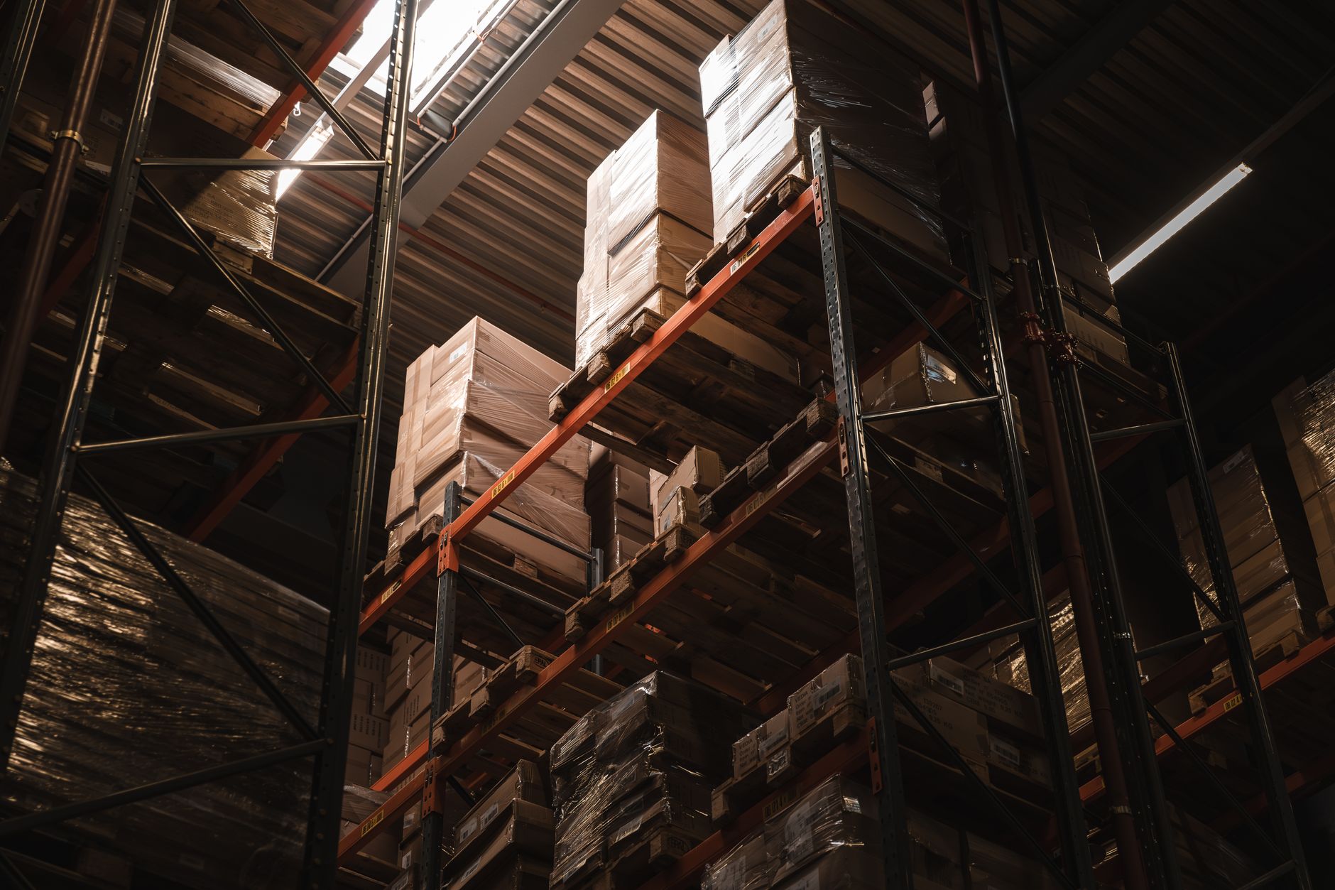 Interior view of a warehouse with stacked cardboard boxes on