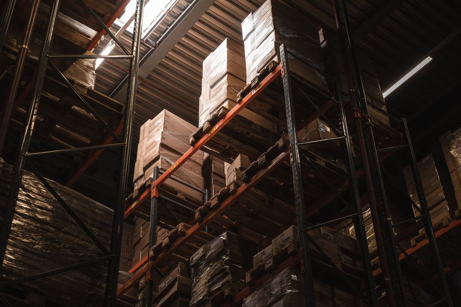 Interior view of a warehouse with stacked cardboard boxes on