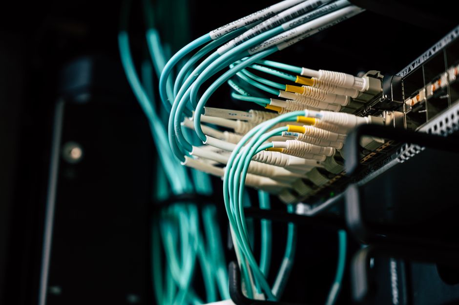 Detailed view of network cables plugged into a server rack i