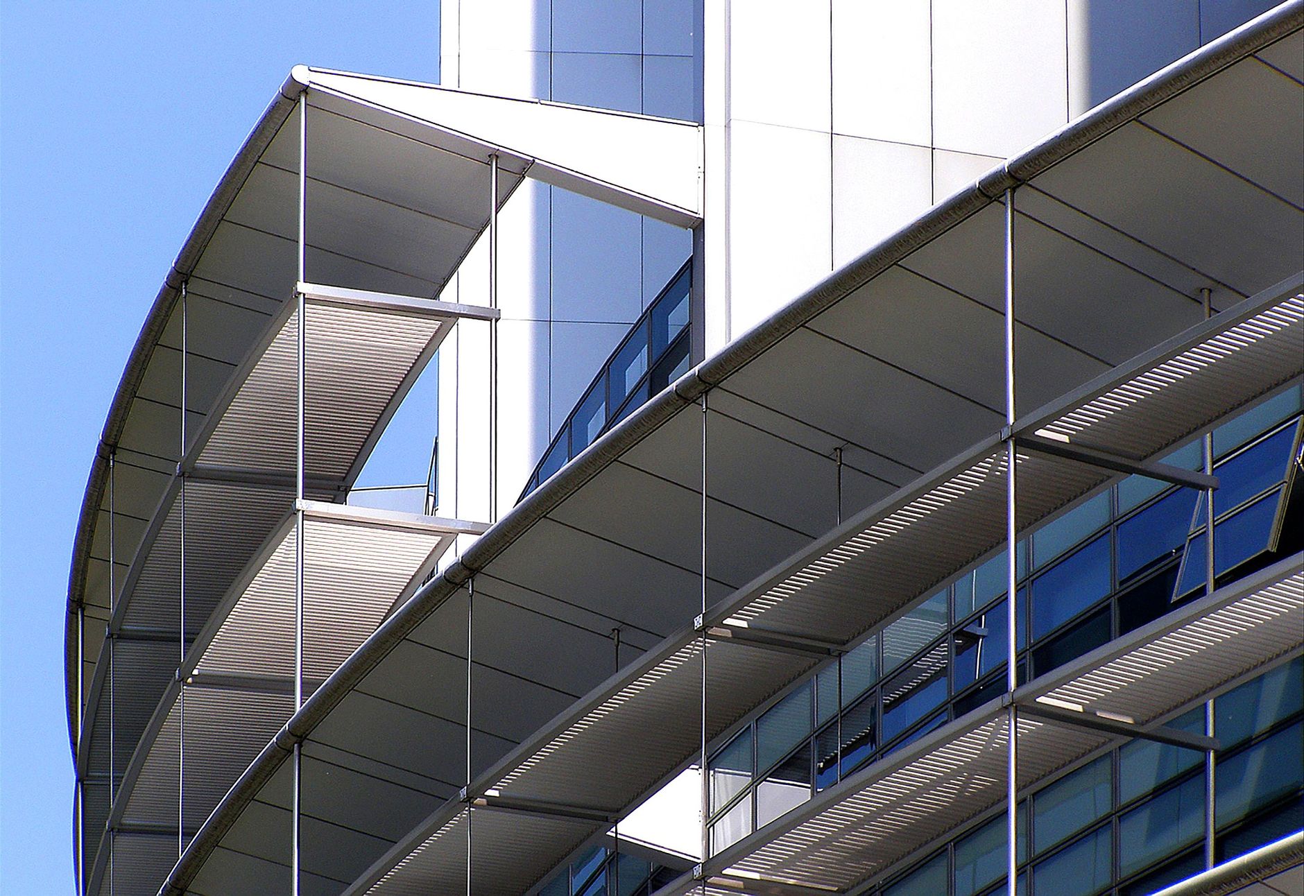 Close-up of a futuristic building facade with glass and meta