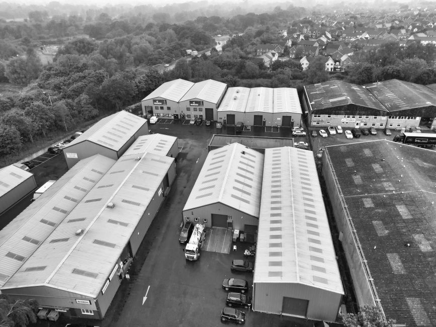 Black and white aerial view of industrial warehouses surroun
