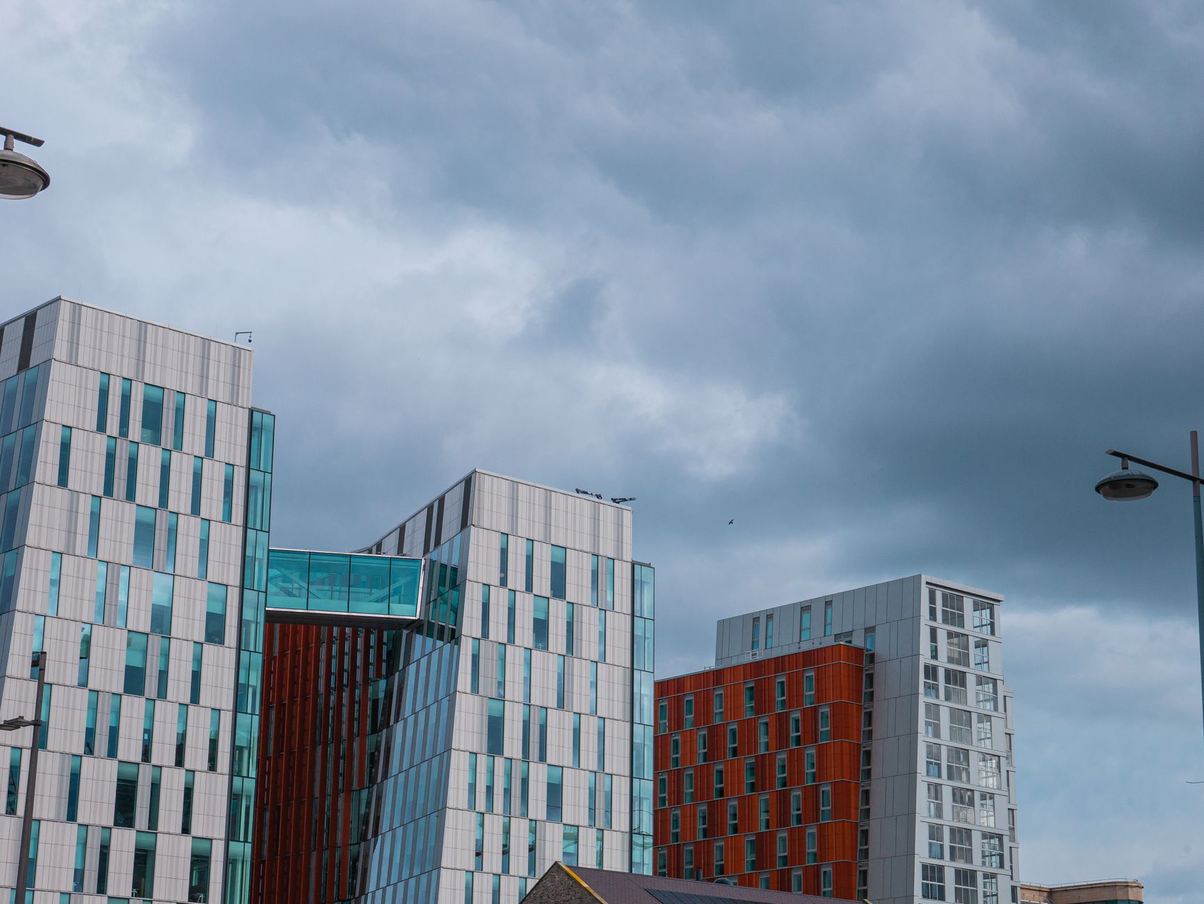 Contemporary buildings in Dublin against a dramatic cloudy s