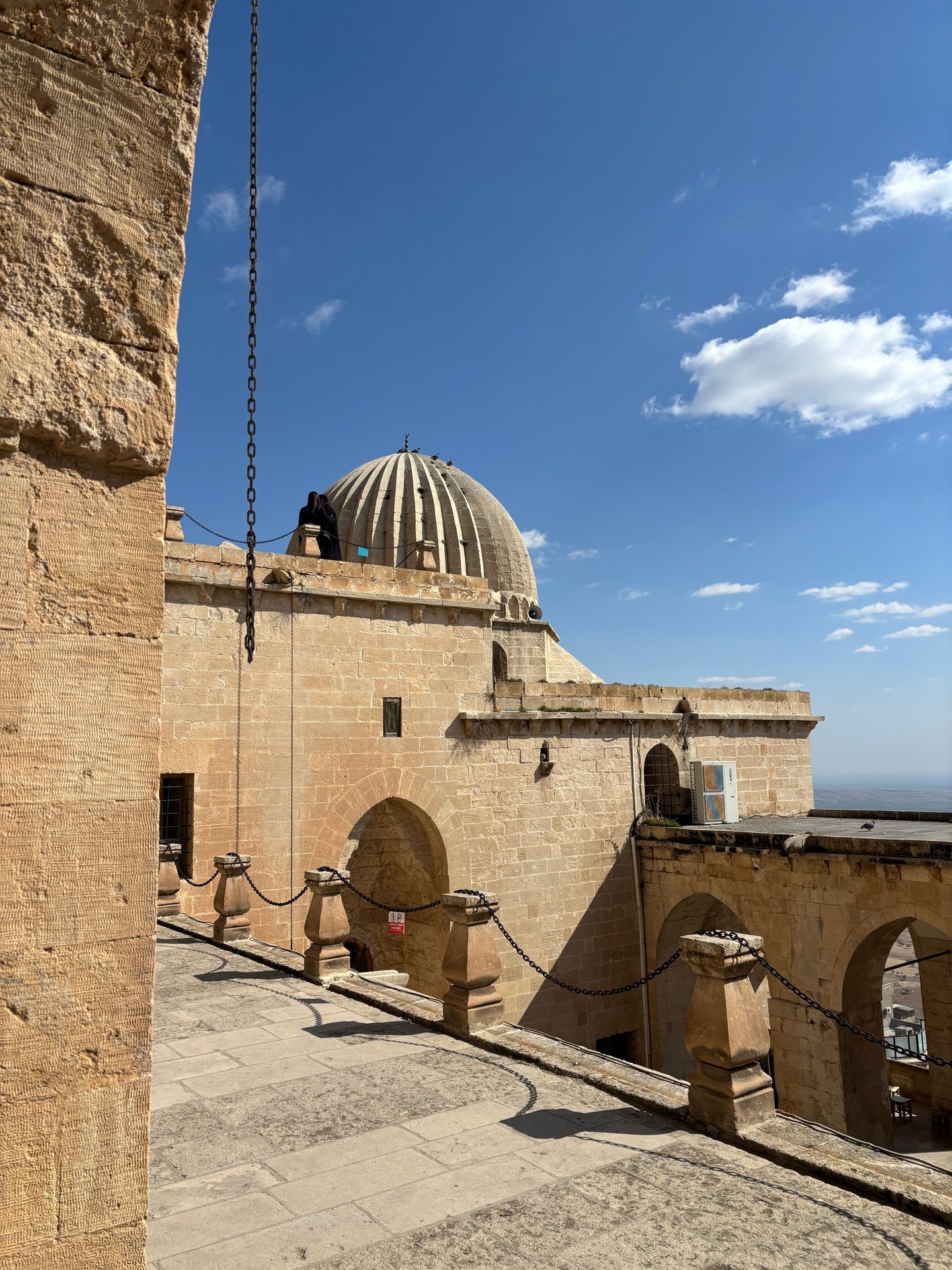 Explore the historic stone architecture and iconic dome in Mardin, Türkiye.