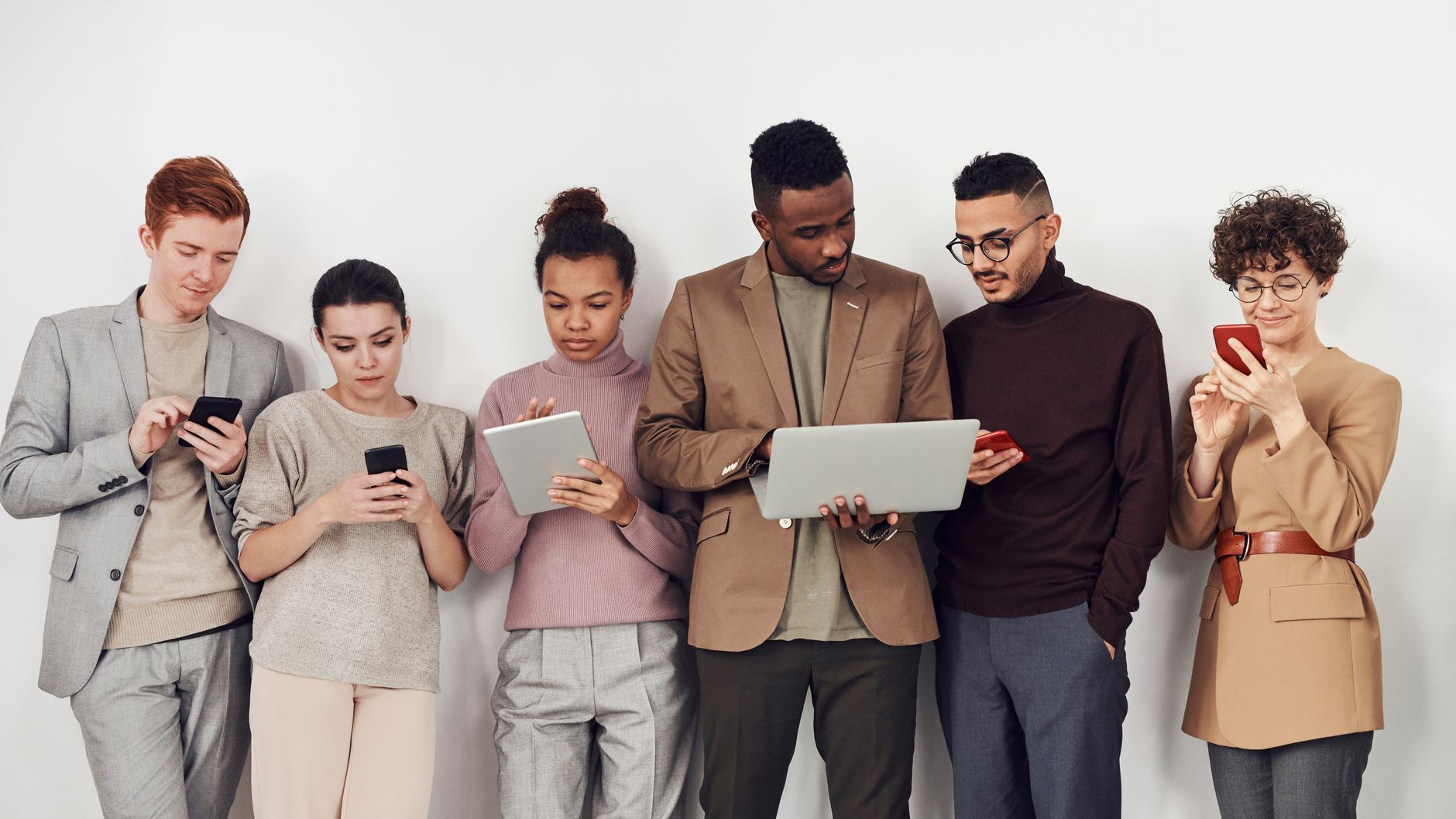 A diverse group of young adults using mobile devices. Perfec