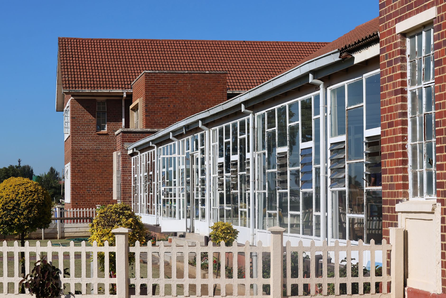Exterior view of a modern brick building with extensive glas