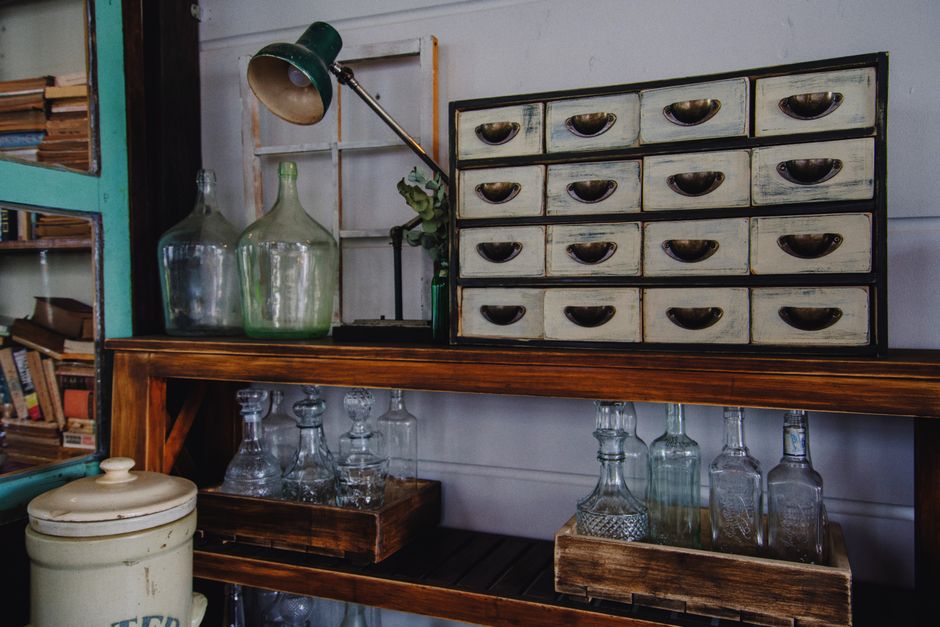 A rustic indoor scene featuring a vintage cabinet and glass