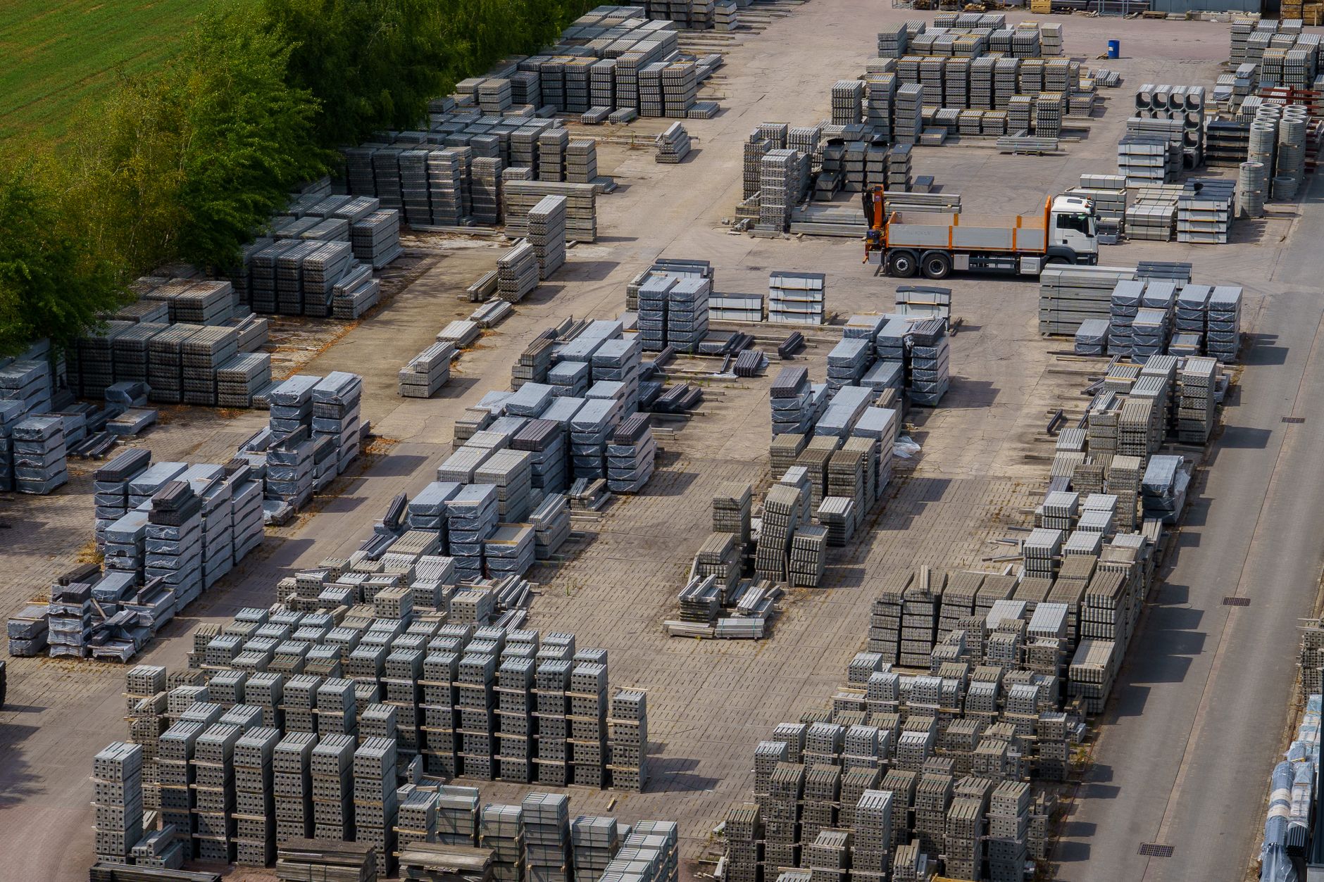 Aerial shot of a vast industrial yard with stacked bricks an