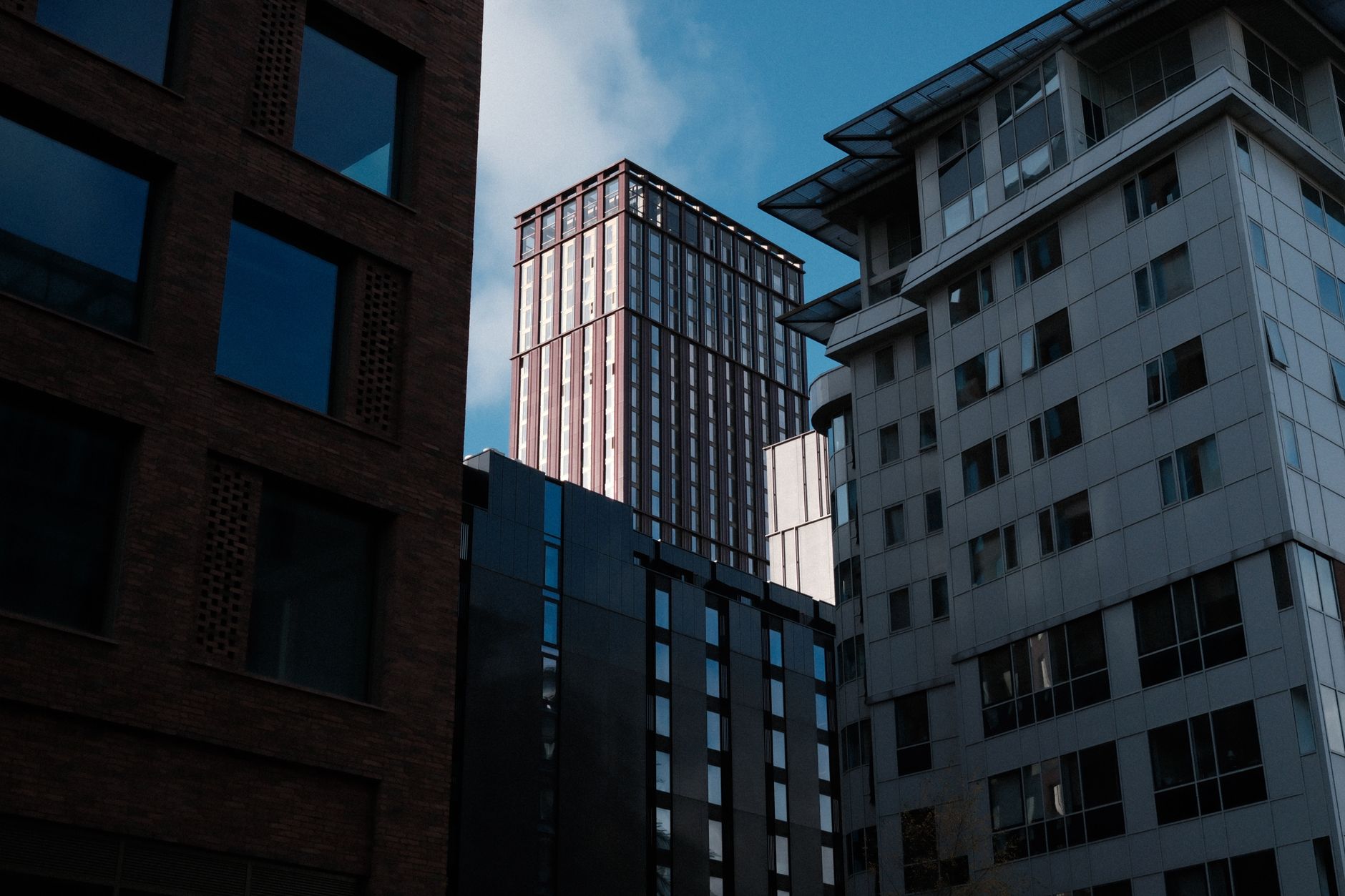 A view of modern skyscrapers framed by contemporary building