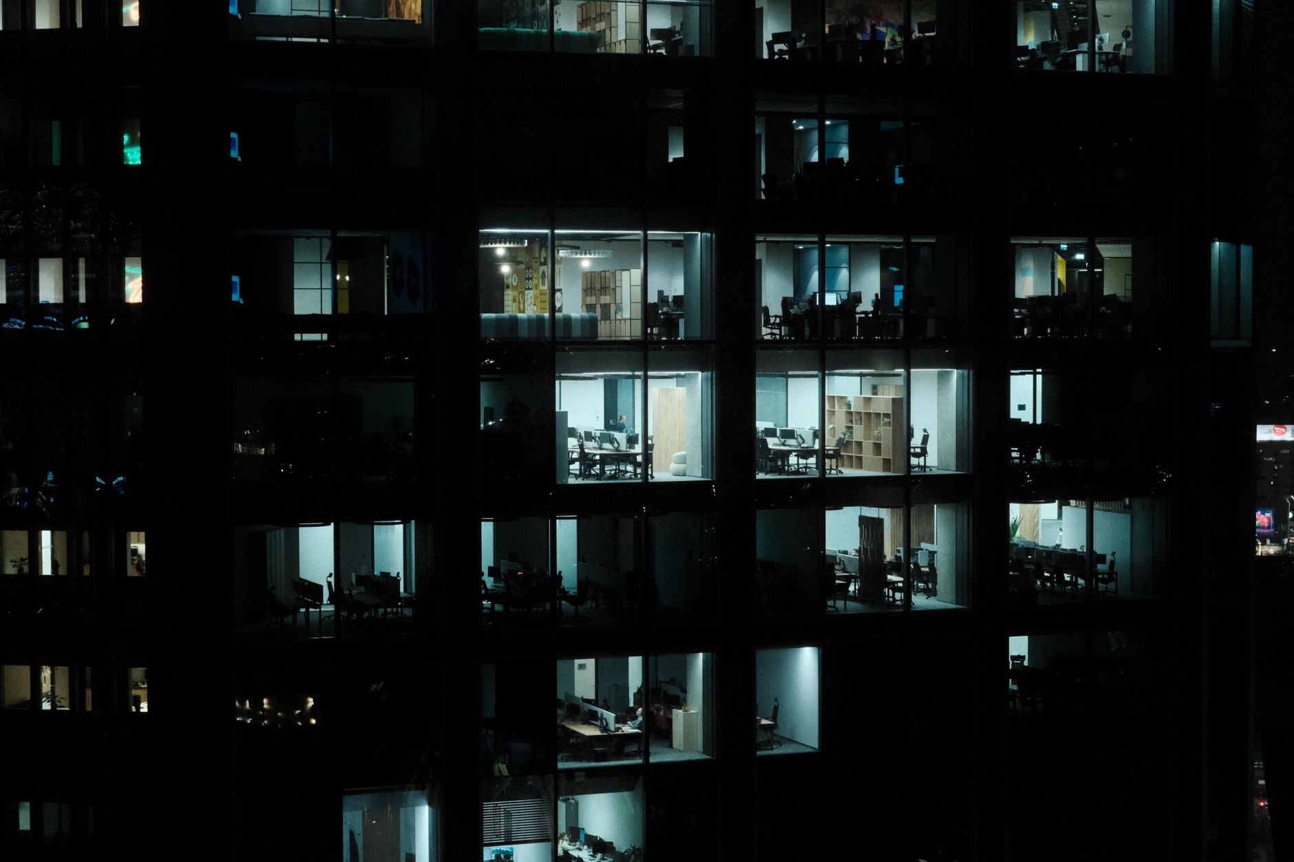 A nighttime view of a modern office building in Warsaw with