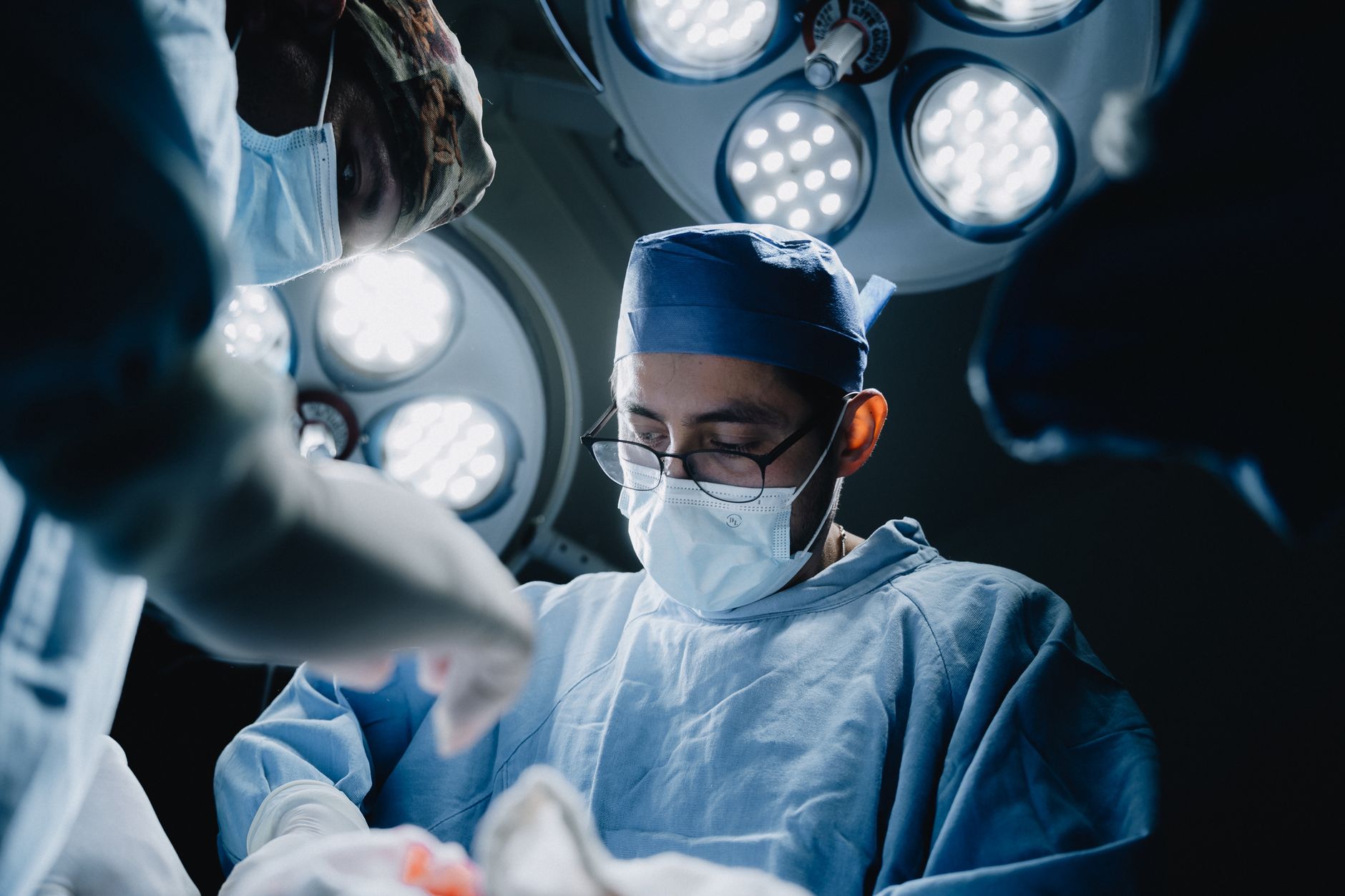 Surgeons performing a medical procedure in a well-lit, moder