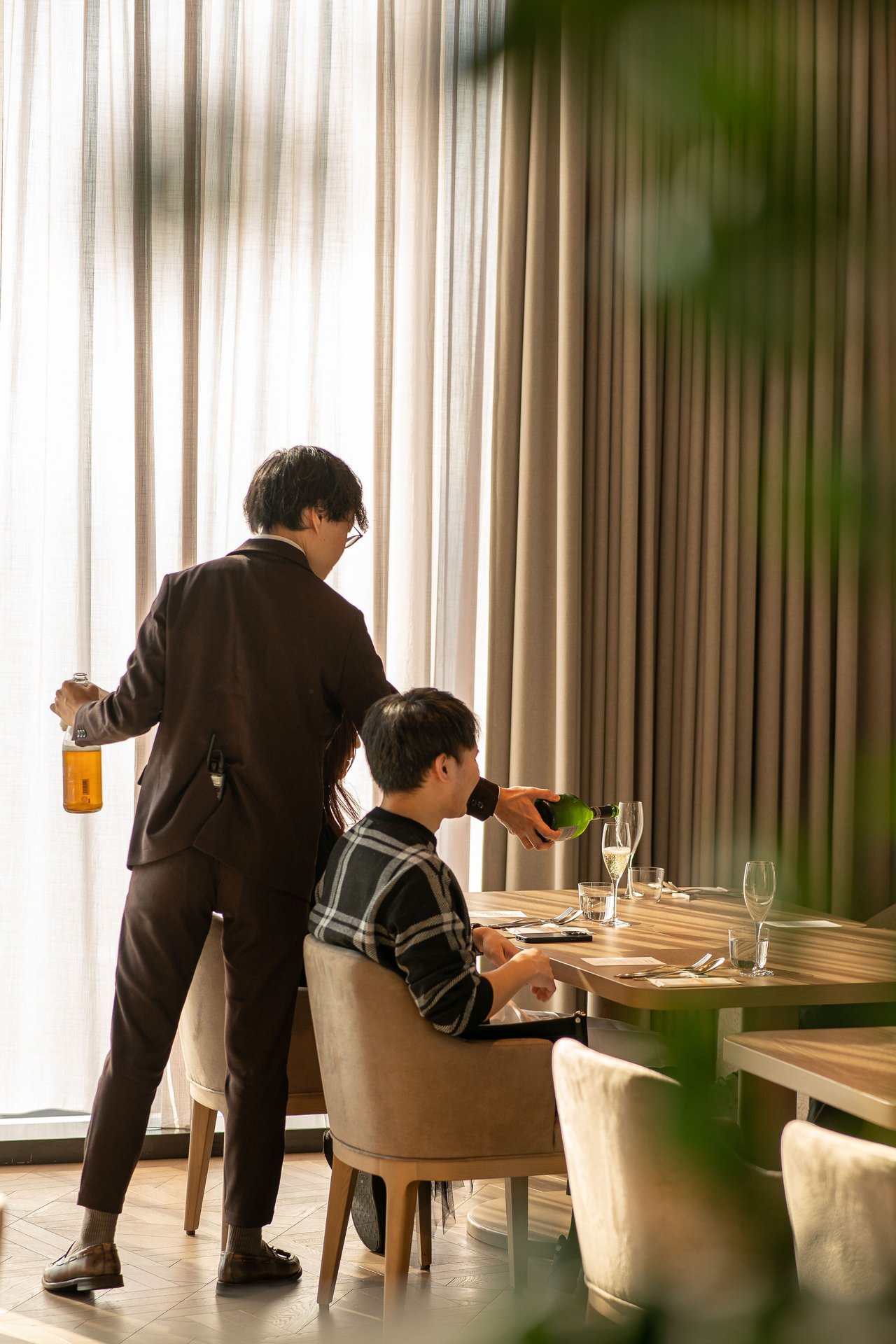 A waiter serves wine in an upscale Tokyo restaurant, capturi