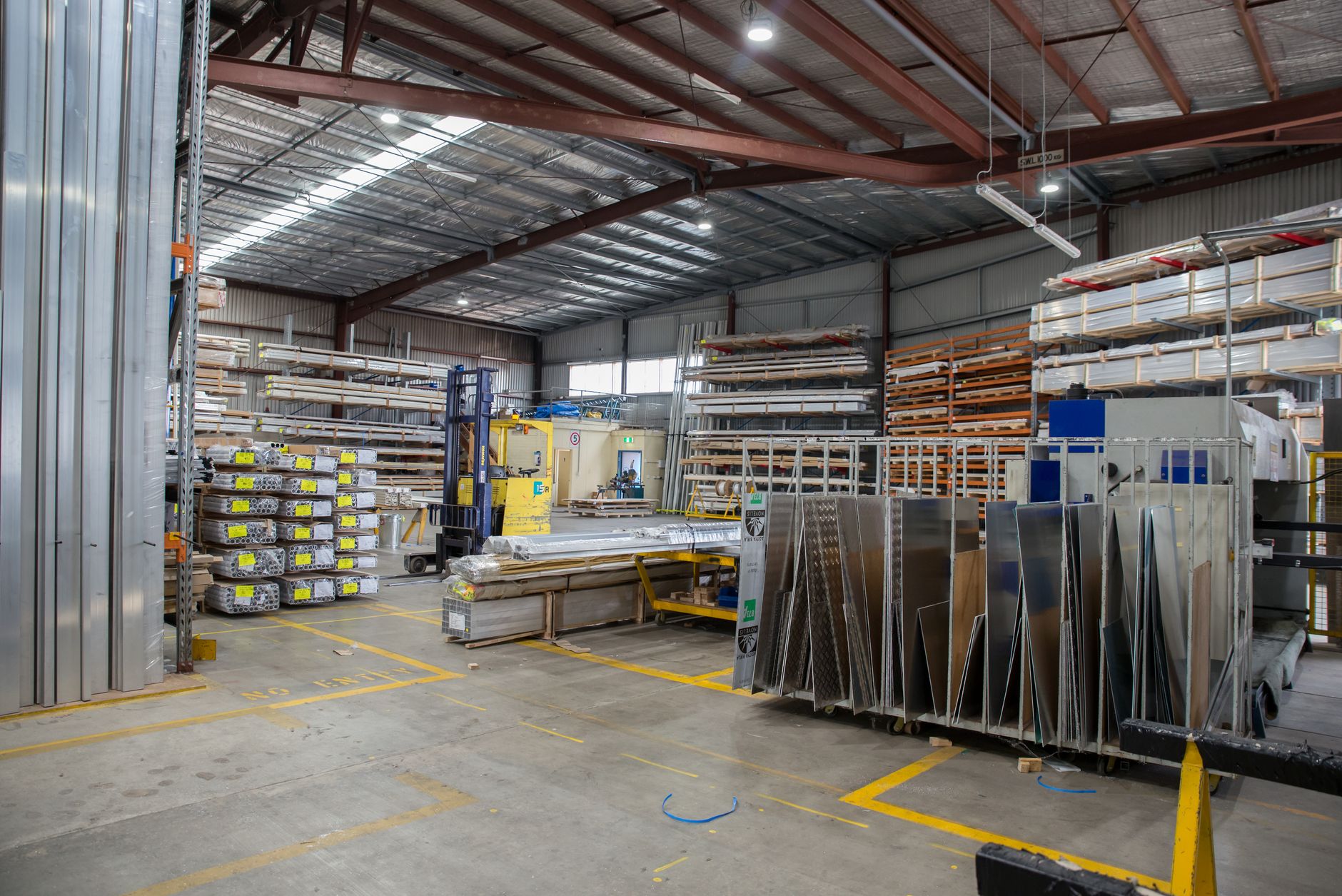 Wide view of an industrial warehouse interior showcasing sta