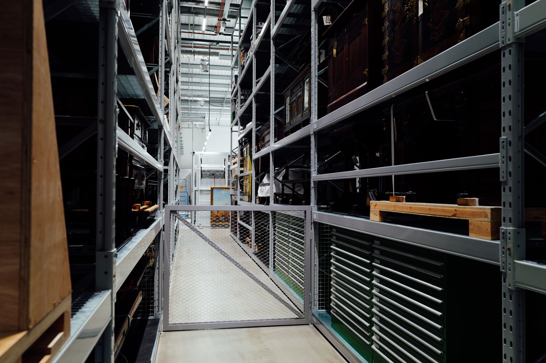 A detailed look at the interior of an industrial storage warehouse with metal shelves.