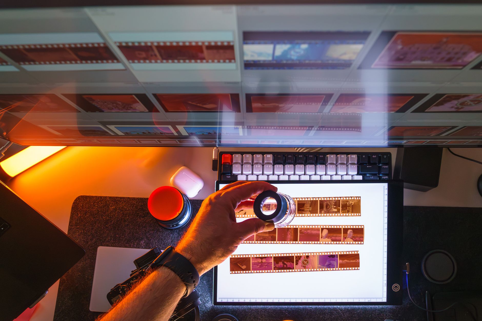 Top view of film negatives being reviewed with a magnifying