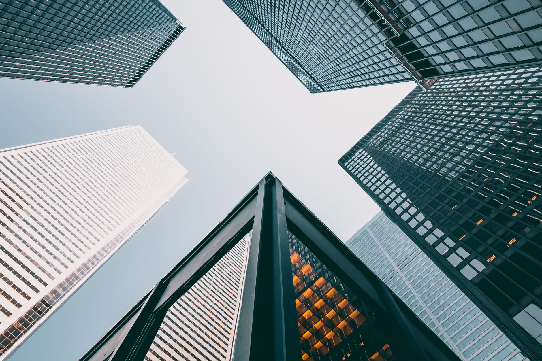 Low angle view of modern skyscrapers with glass facades agai