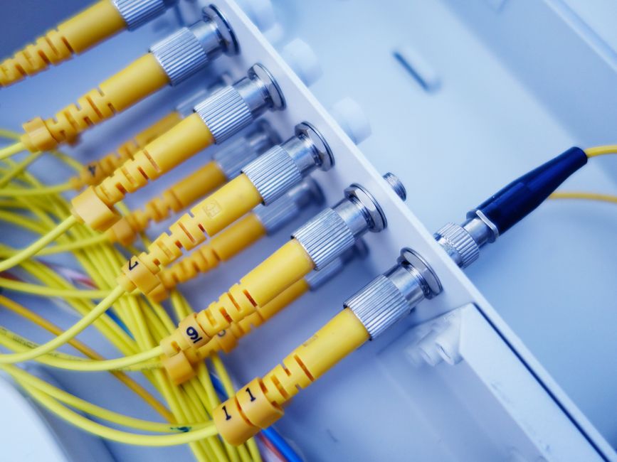 Close-up of yellow fiber optic cables in a network server, s