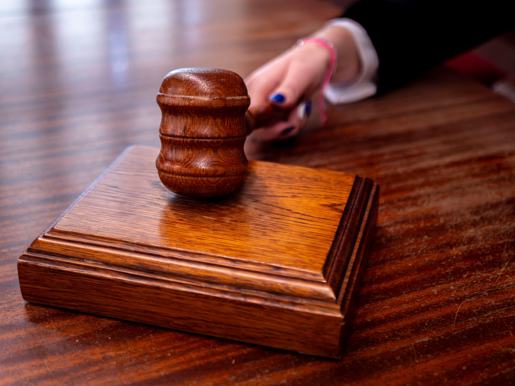 Close-up of a wooden judge's gavel on a desk in a courtroom,