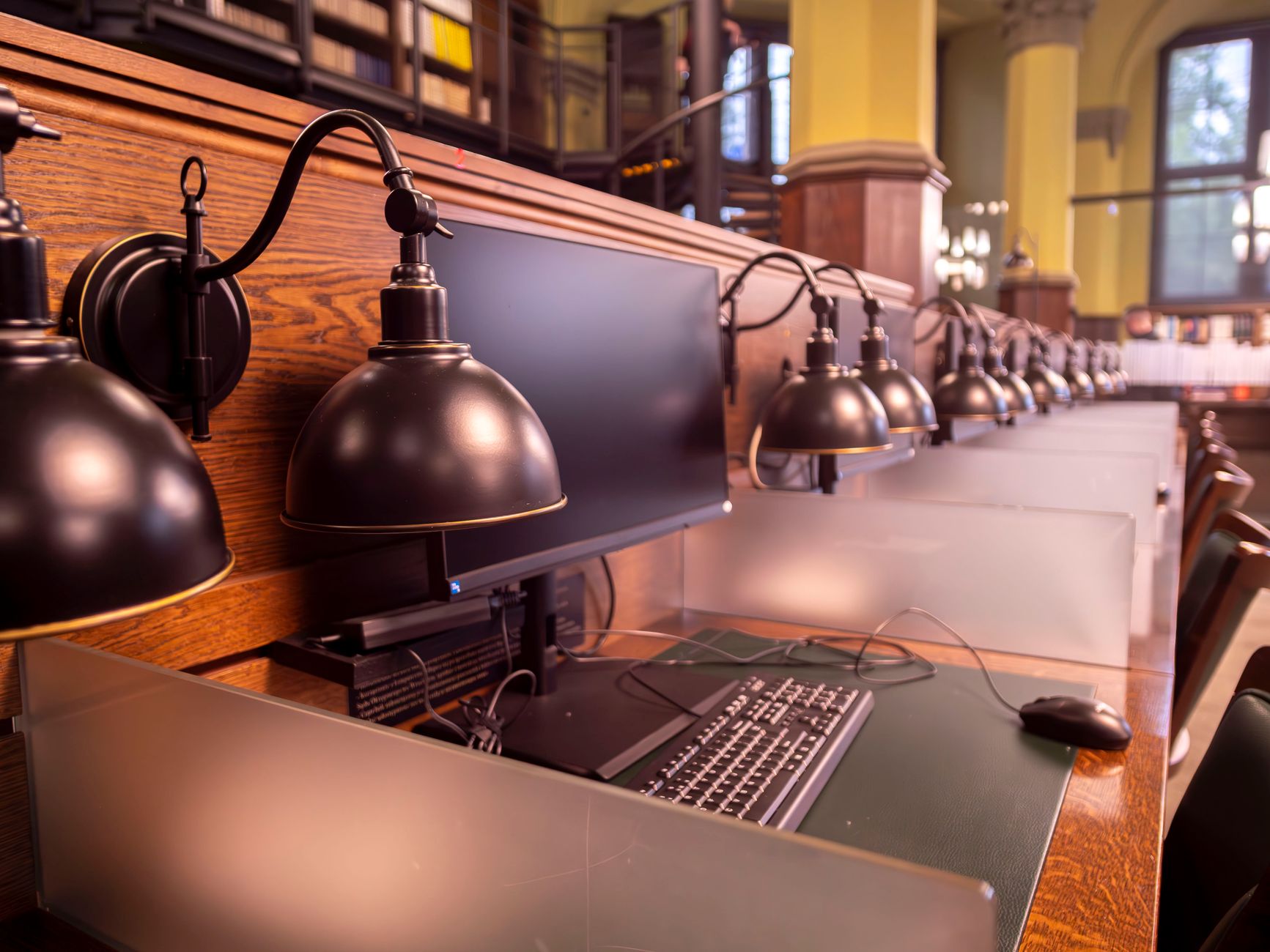 A row of computer workstations in a modern library in Wrocła