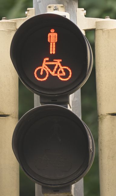 Traffic signal with red light for bicycles and pedestrians,