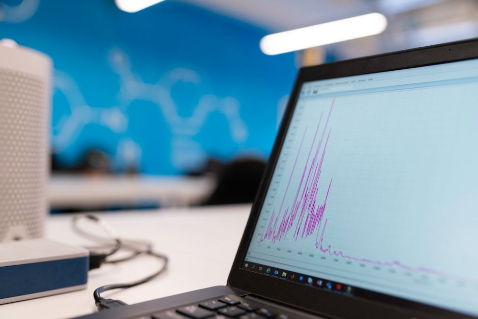 Laptop displaying data analytics graph in a modern office se
