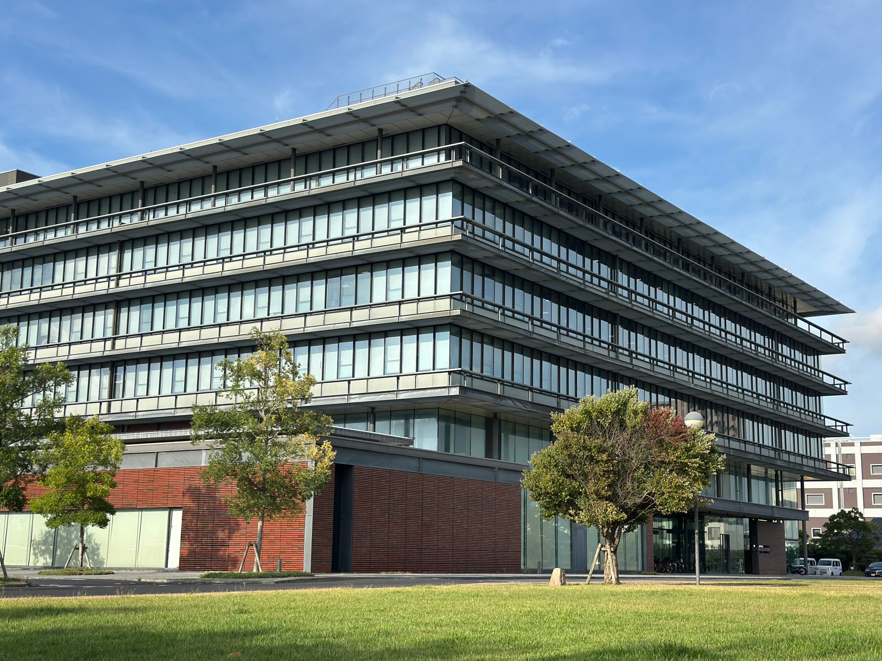 A contemporary office building featuring a striking glass fa