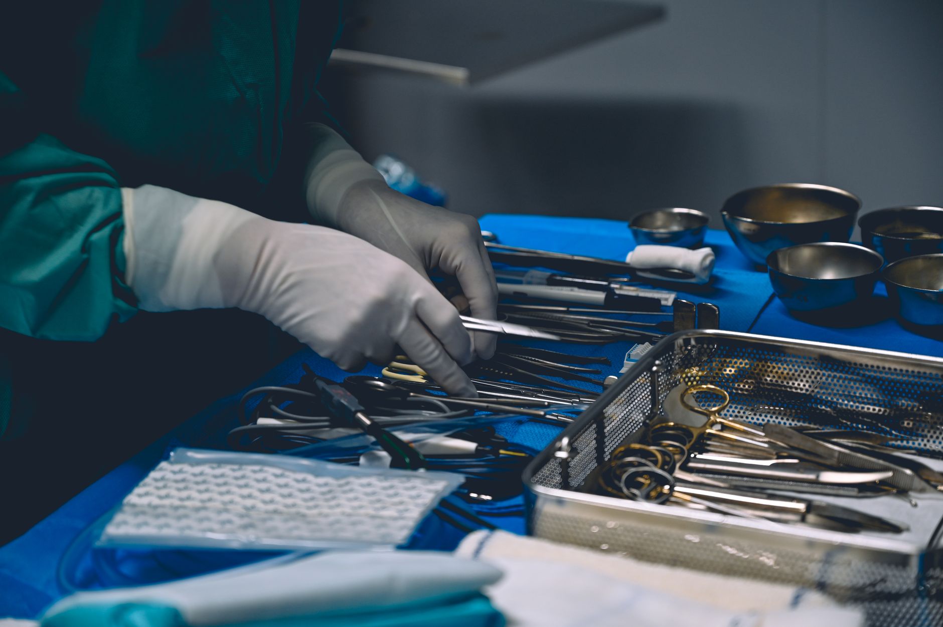 Surgeon organizing surgical instruments on a sterile table b