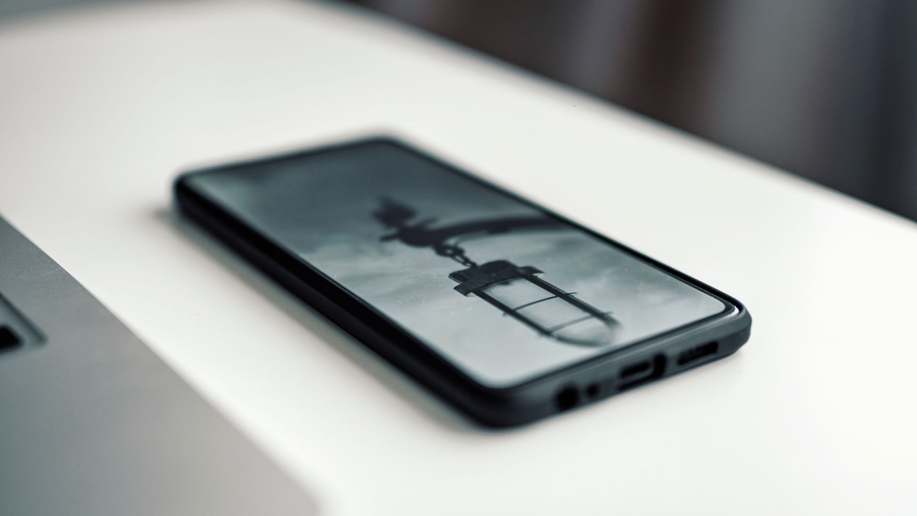 Close-up of a smartphone displaying a blurred image, placed