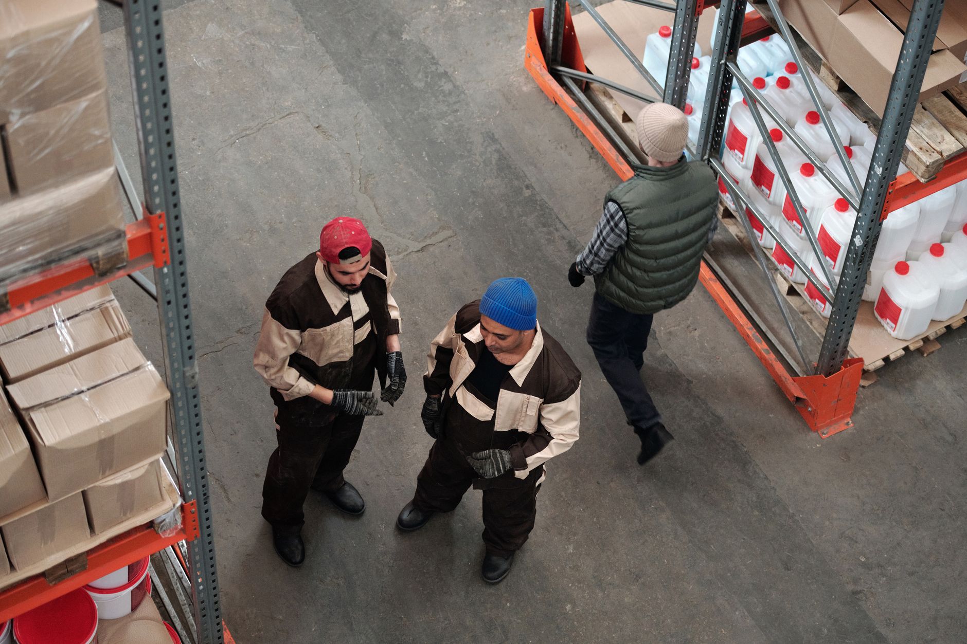 High angle view of warehouse workers organizing boxes and co